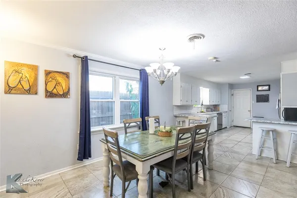 a view of a dining room with furniture and a chandelier