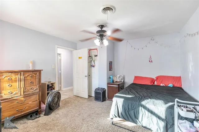 a bedroom with a bed and a view of closet