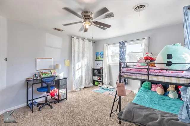a living room filled with furniture and a wooden floor