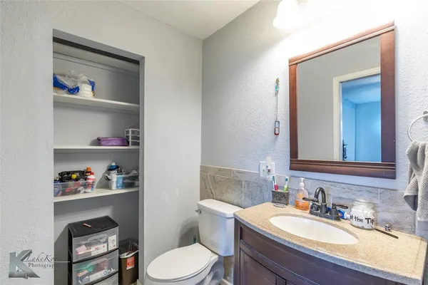 a bathroom with a toilet a sink and a mirror