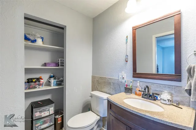 a bathroom with a toilet a sink and a mirror