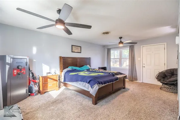 a bedroom with a bed couch and window