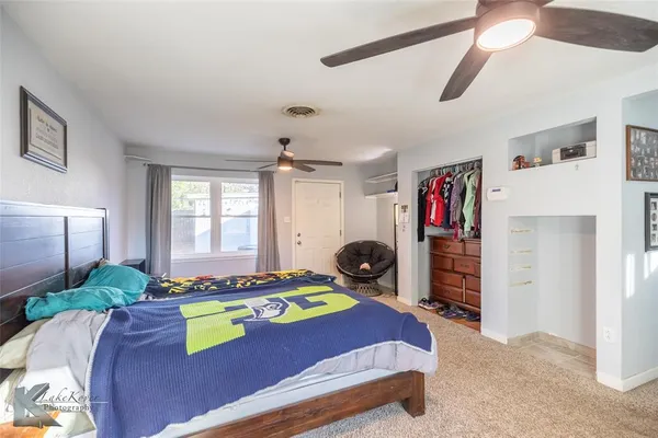 a bedroom with bed and a window