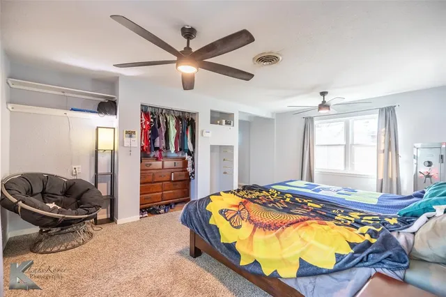 a bedroom with a bed and dresser