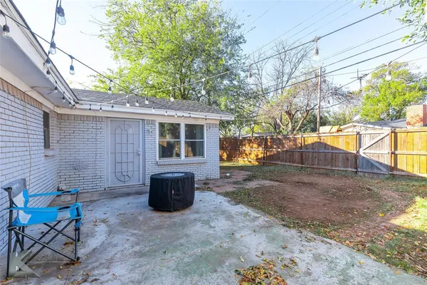 a view of a patio with table and chairs and potted plants