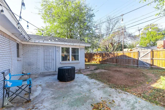 a view of a patio with table and chairs and potted plants