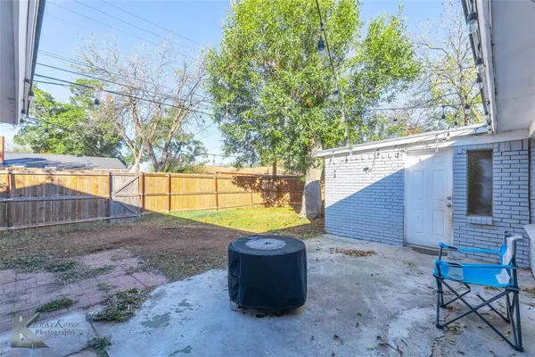 a view of a backyard with plants and sitting area