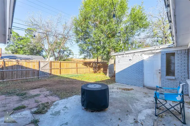 a view of a backyard with plants and sitting area