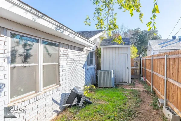 a backyard of a house with table and chairs