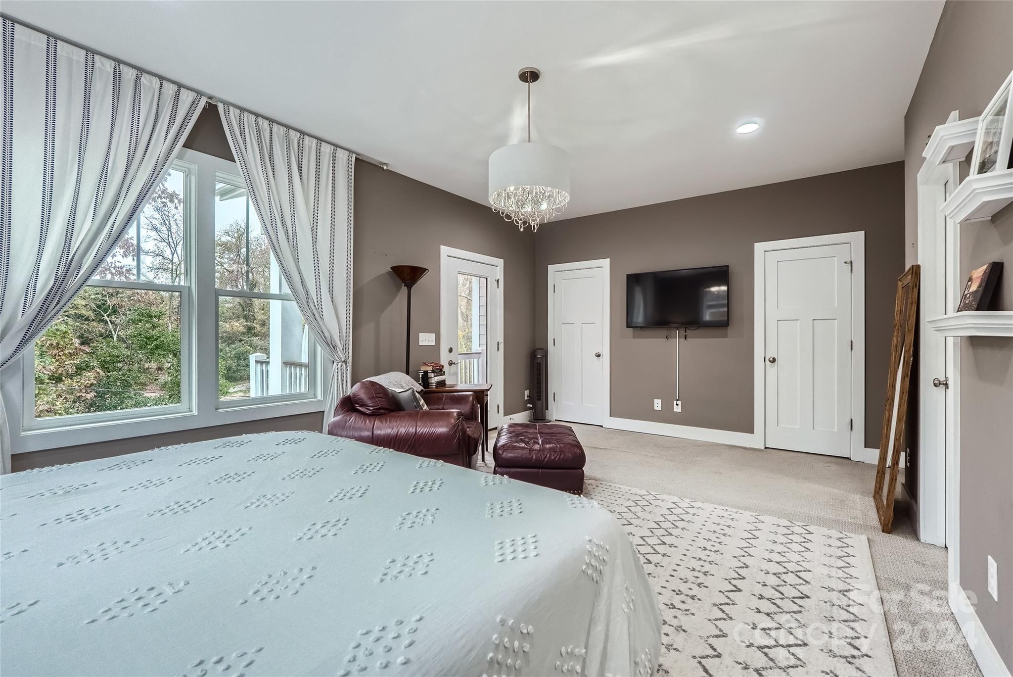 5220 Valley Stream Road Charlotte, NC 28209 - Photo 12 of 24 a spacious bedroom with a large bed and a window