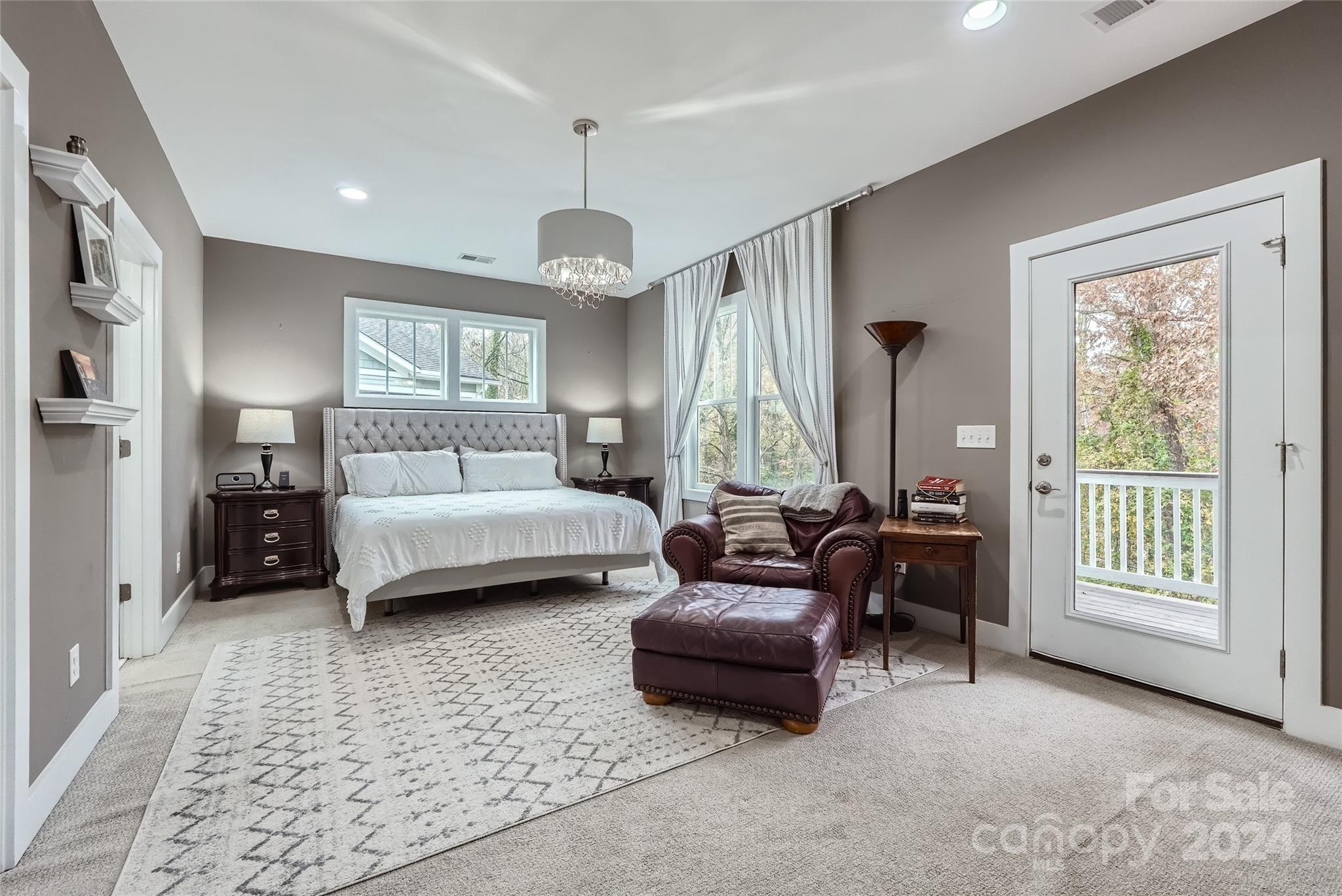 5220 Valley Stream Road Charlotte, NC 28209 - Photo 14 of 24 a bedroom with furniture and a chandelier