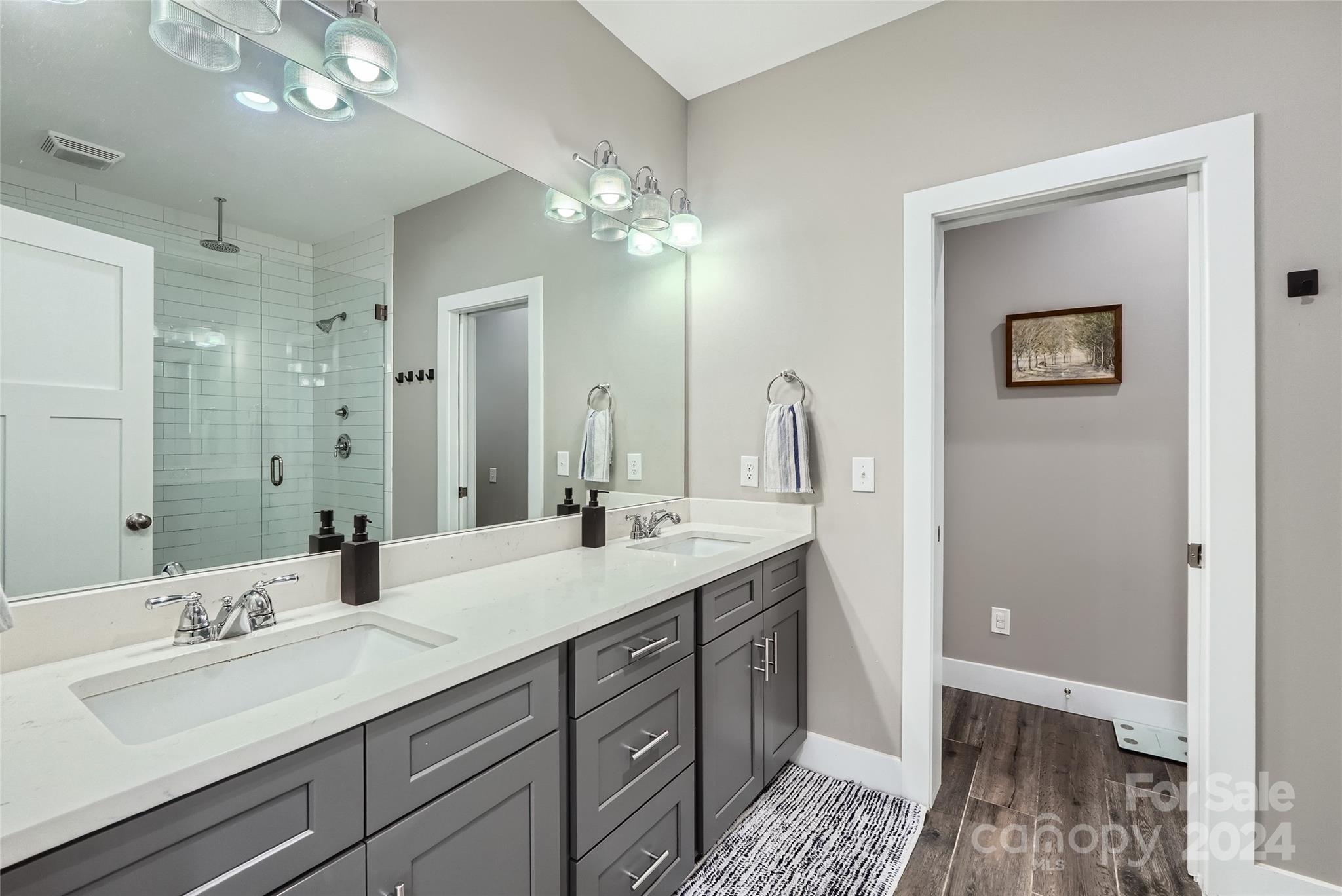 5220 Valley Stream Road Charlotte, NC 28209 - Photo 15 of 24 a bathroom with a double vanity sink and a mirror