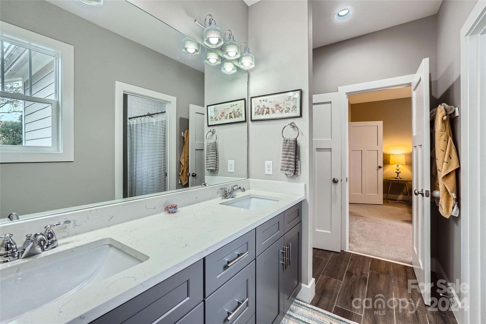 5220 Valley Stream Road Charlotte, NC 28209 - Photo 19 of 24 a spacious bathroom with a double vanity sink shower and a mirror