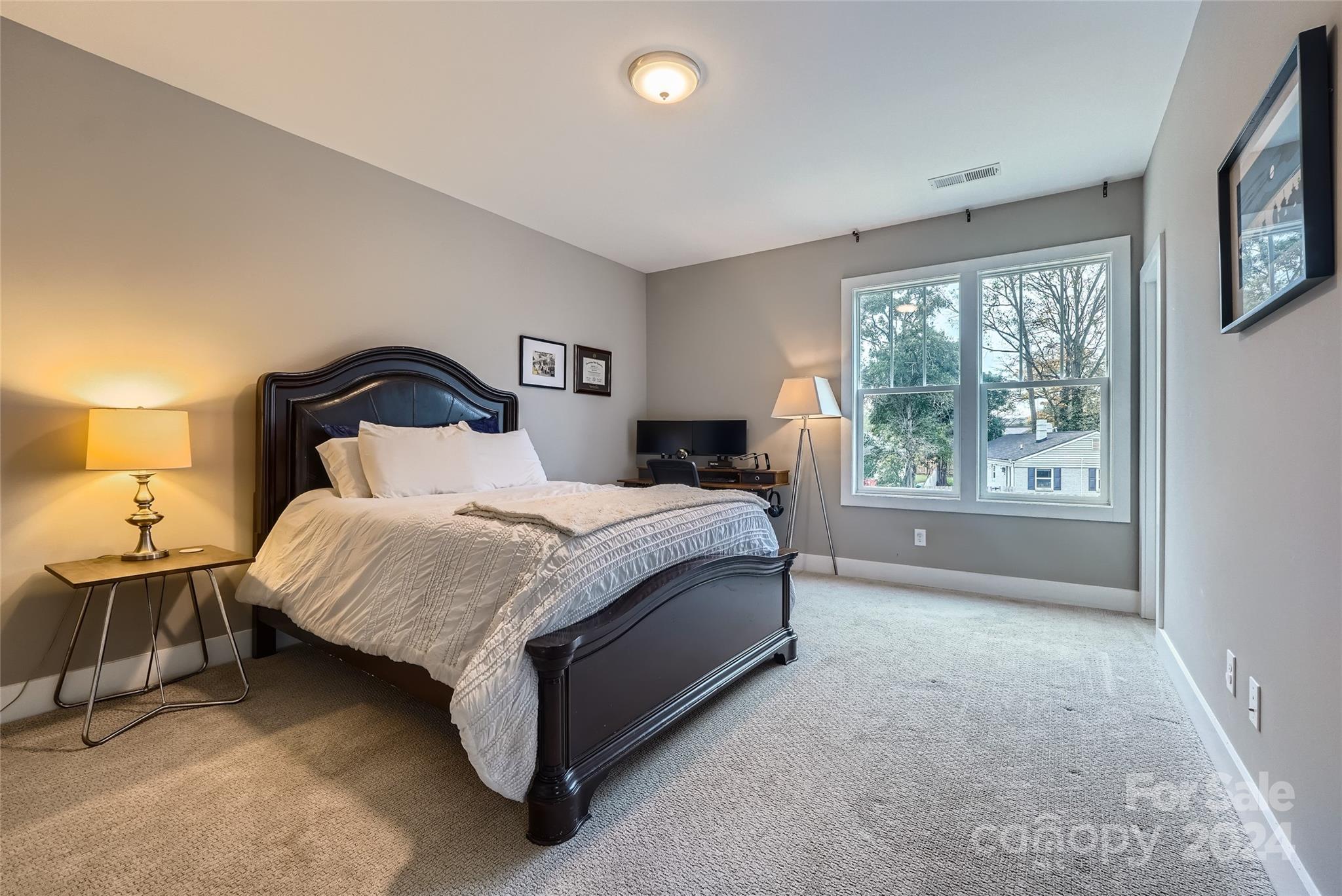 5220 Valley Stream Road Charlotte, NC 28209 - Photo 20 of 24 a spacious bedroom with a bed and large windows