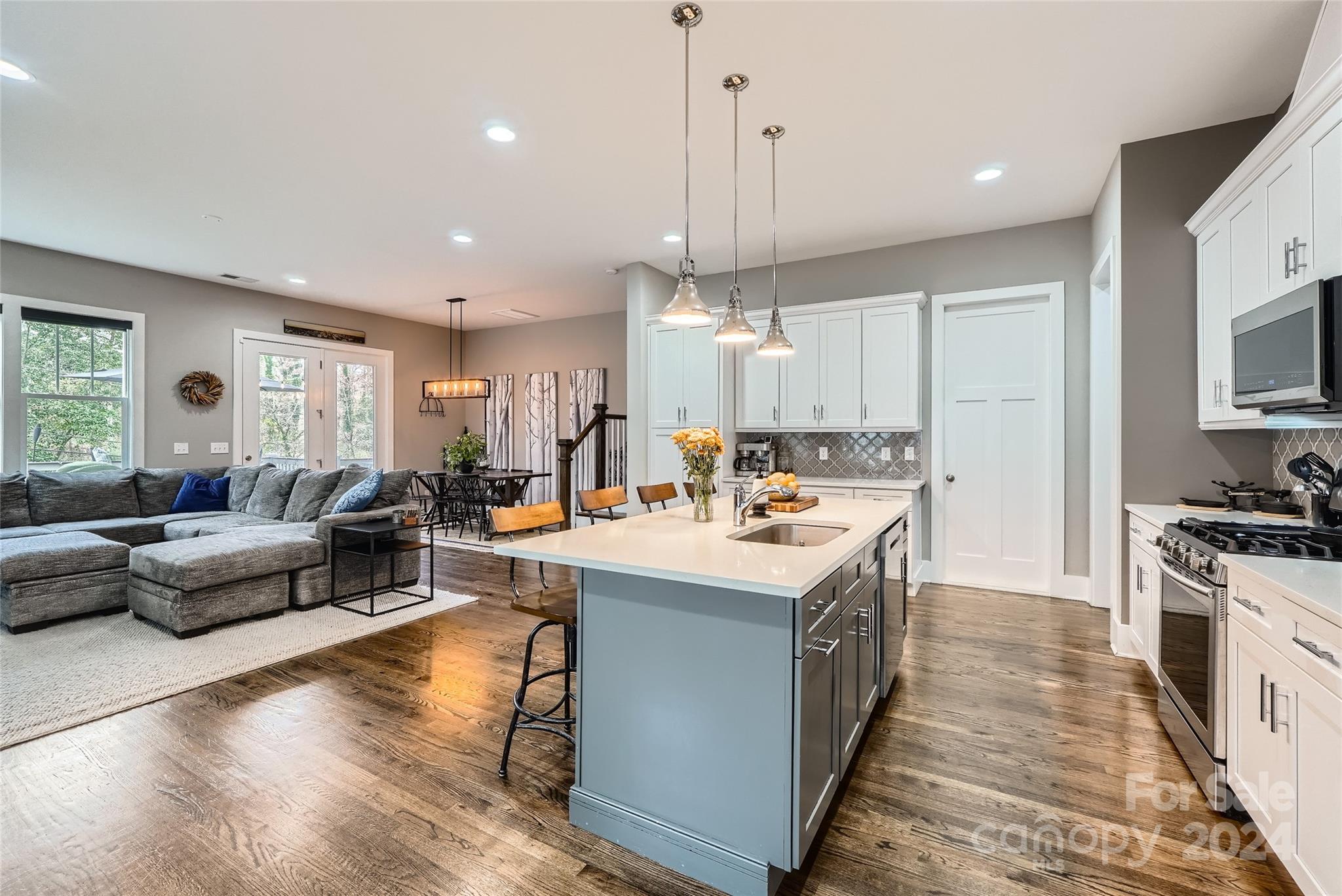 5220 Valley Stream Road Charlotte, NC 28209 - Photo 6 of 24 a large kitchen with stainless steel appliances kitchen island granite countertop a large center island a sink a stove and a window