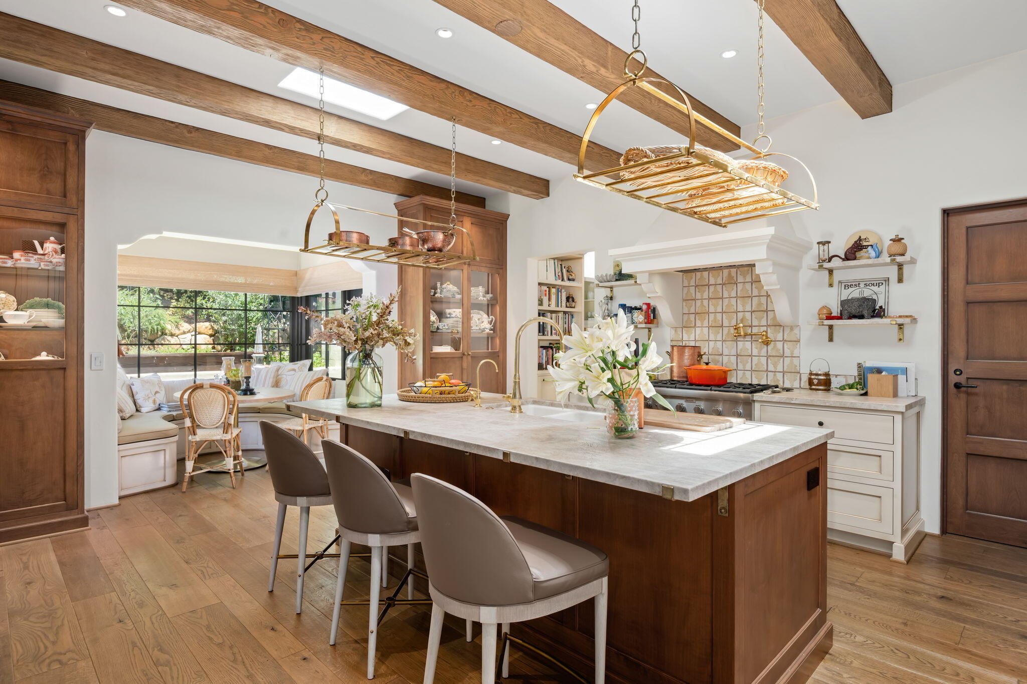 0 Boundary Drive Montecito, CA 93108 - Photo 8 of 26 a kitchen with stainless steel appliances granite countertop a table chairs and a wooden floor