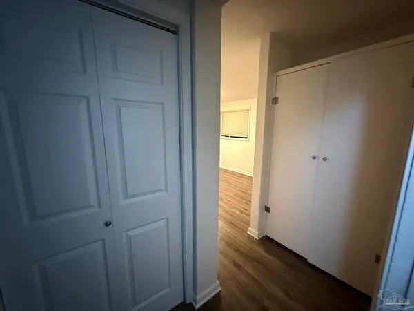 a view of an entryway with wooden floor