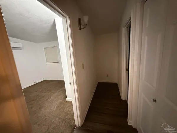 a view of a hallway with wooden floor and entryway