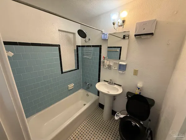 a bathroom with a sink a toilet and mirror