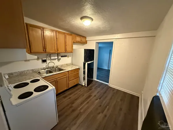 a kitchen with a sink a stove and a refrigerator