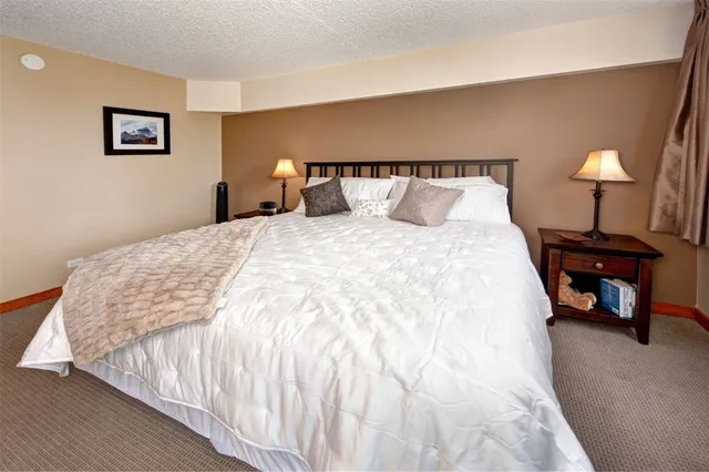 a bedroom with a bed and a night stand