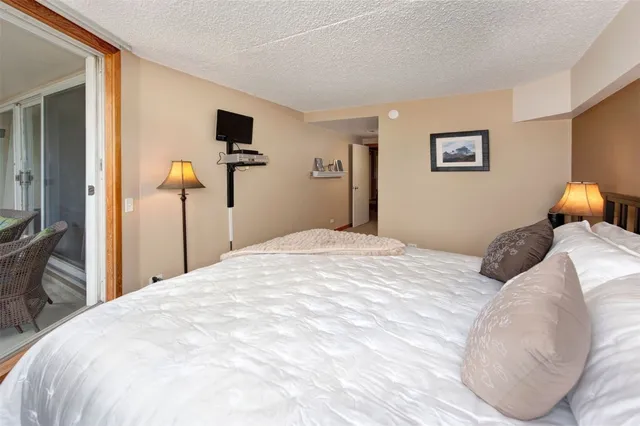 a bedroom with a bed and a tv