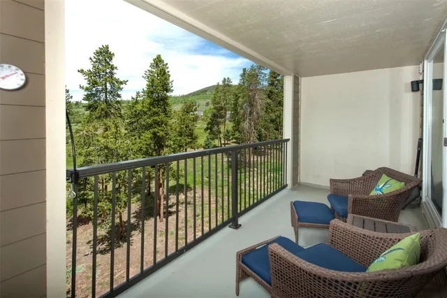 a balcony with table and chairs