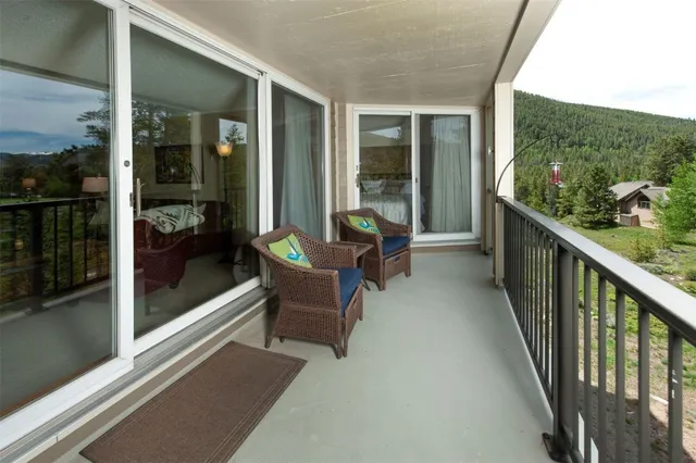 a view of a porch with furniture and floor to ceiling window