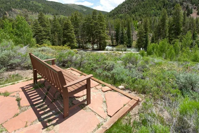 a view of a wooden deck with mountain view and wooden floor