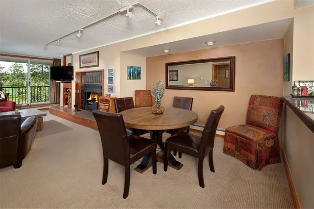 a dining room with furniture window and outside view