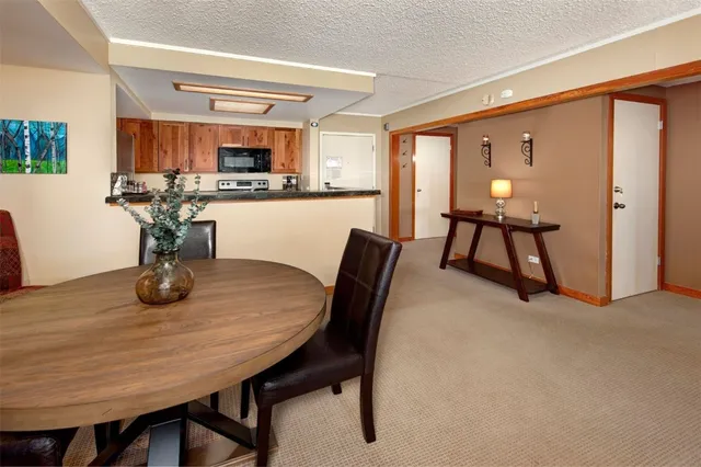 a dining room with furniture and wooden floor