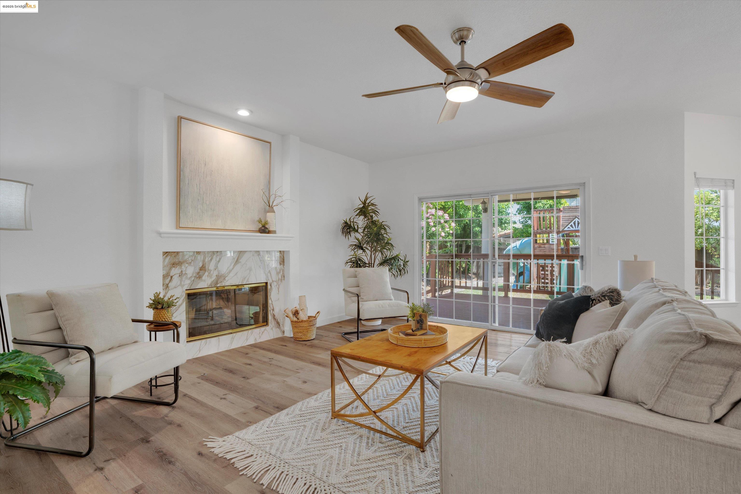 805 Devonshire Loop Brentwood, CA 94513 - Photo 14 of 51 a living room with furniture a fireplace and a large window