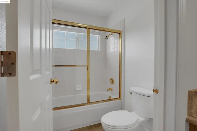 a bathroom with a shower a toilet and a sink