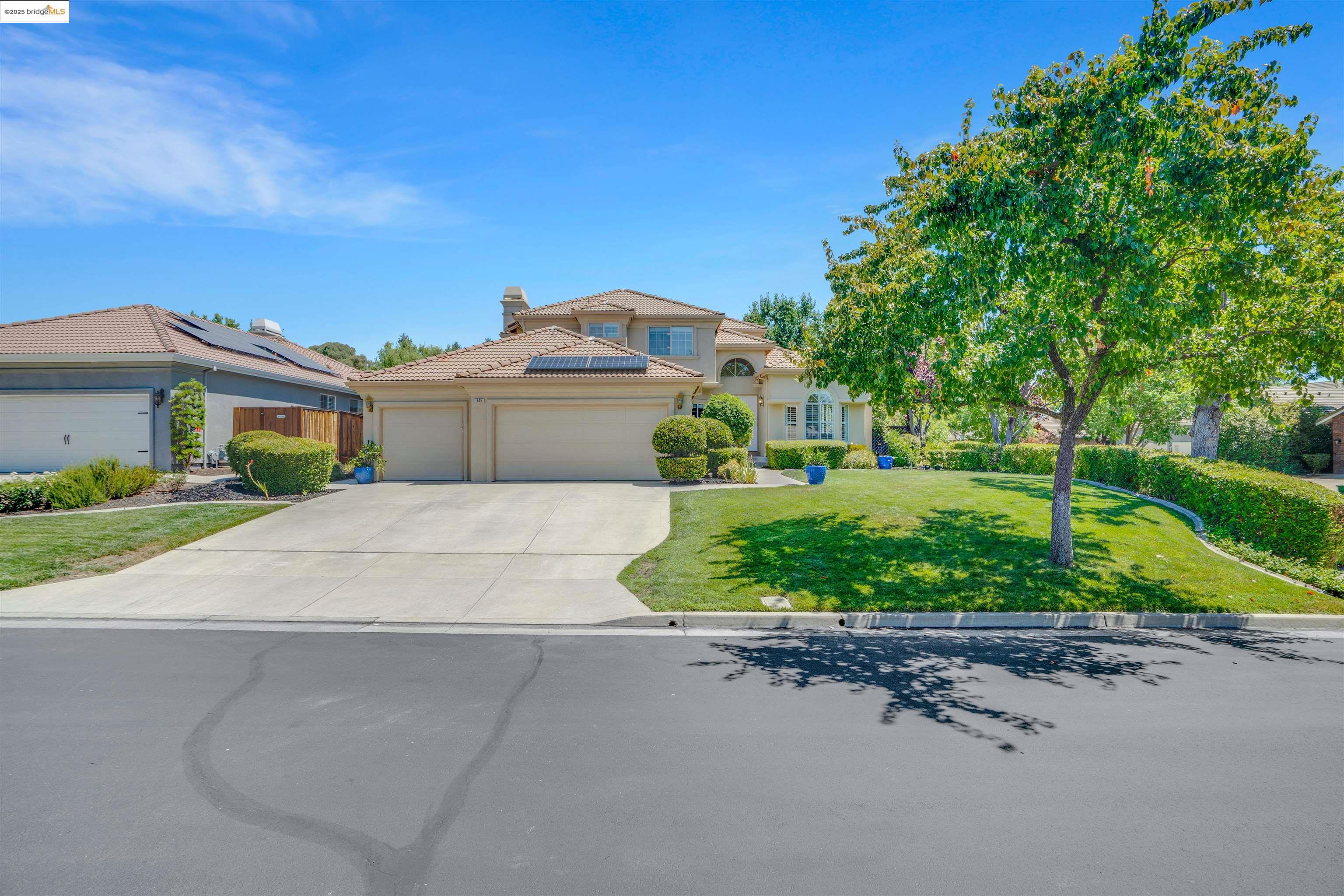 805 Devonshire Loop Brentwood, CA 94513 - Photo 3 of 51 a front view of a house with a yard and potted plants