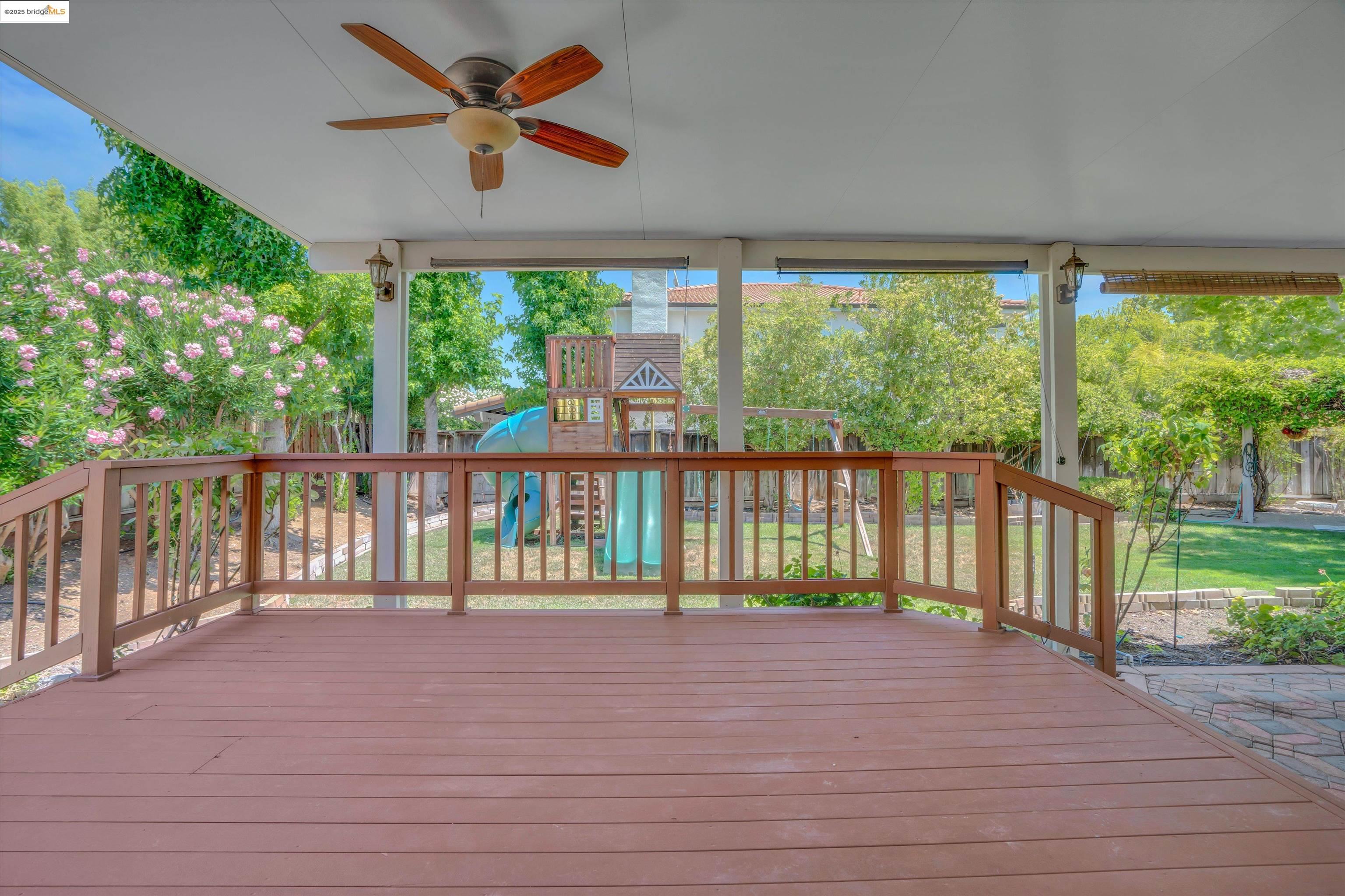 805 Devonshire Loop Brentwood, CA 94513 - Photo 31 of 51 a view of a deck with a floor to ceiling window next to a yard
