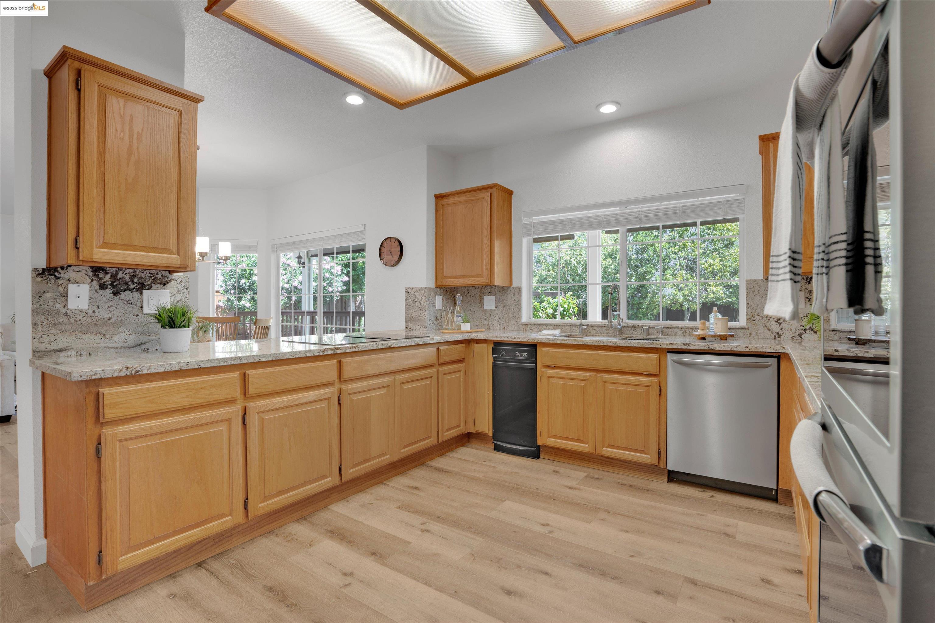 805 Devonshire Loop Brentwood, CA 94513 - Photo 9 of 51 a kitchen with stainless steel appliances granite countertop a stove a sink and a microwave