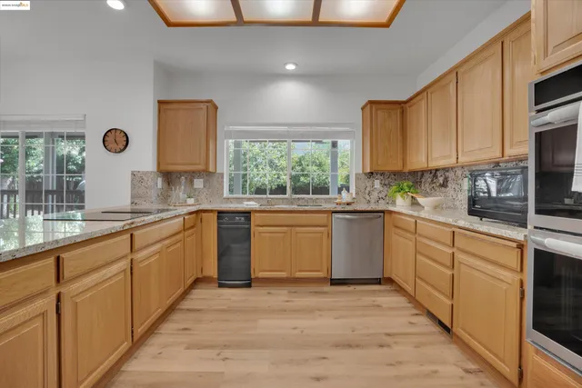 a kitchen with a sink window and cabinets