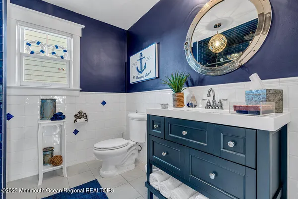 a bathroom with a toilet a sink and a mirror