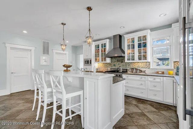 a open kitchen with white cabinets and stainless steel appliances