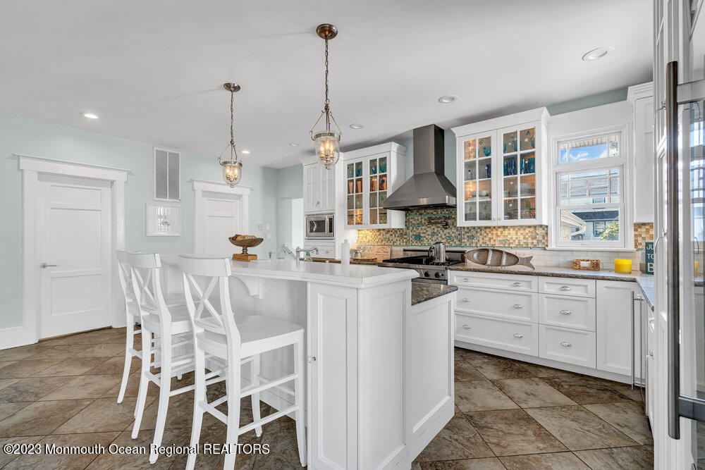 304 Atlantic Avenue Point Pleasant Beach, NJ 08742 - Photo 5 of 20 a open kitchen with white cabinets and stainless steel appliances