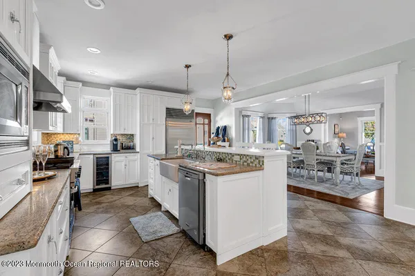 a kitchen with kitchen island granite countertop lots of counter top space and stainless steel appliances
