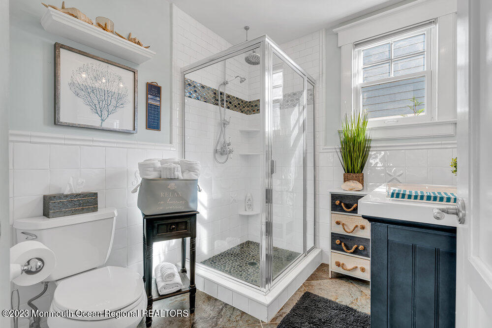 304 Atlantic Avenue Point Pleasant Beach, NJ 08742 - Photo 7 of 20 a bathroom with a granite countertop sink a toilet and shower