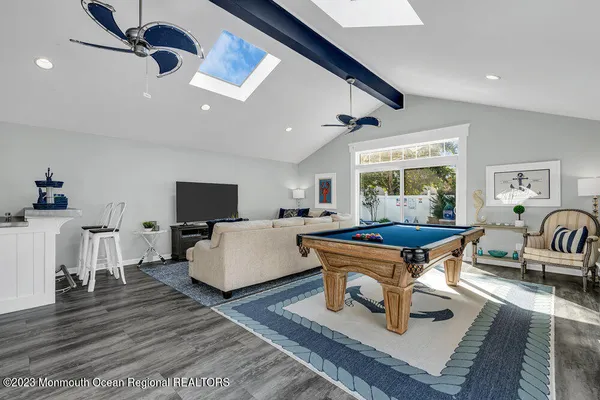 a living room with furniture a flat screen tv and a large window