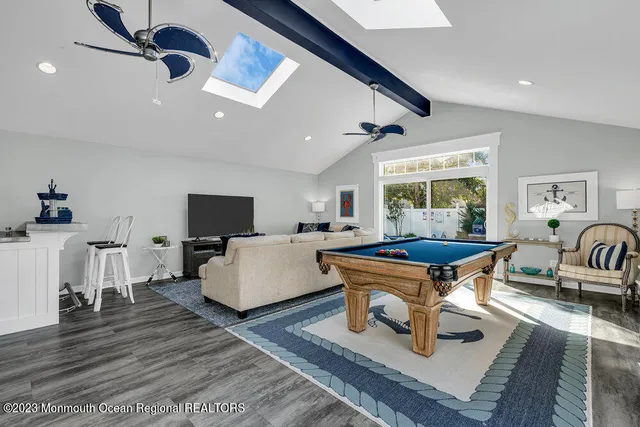 a living room with furniture a flat screen tv and a large window