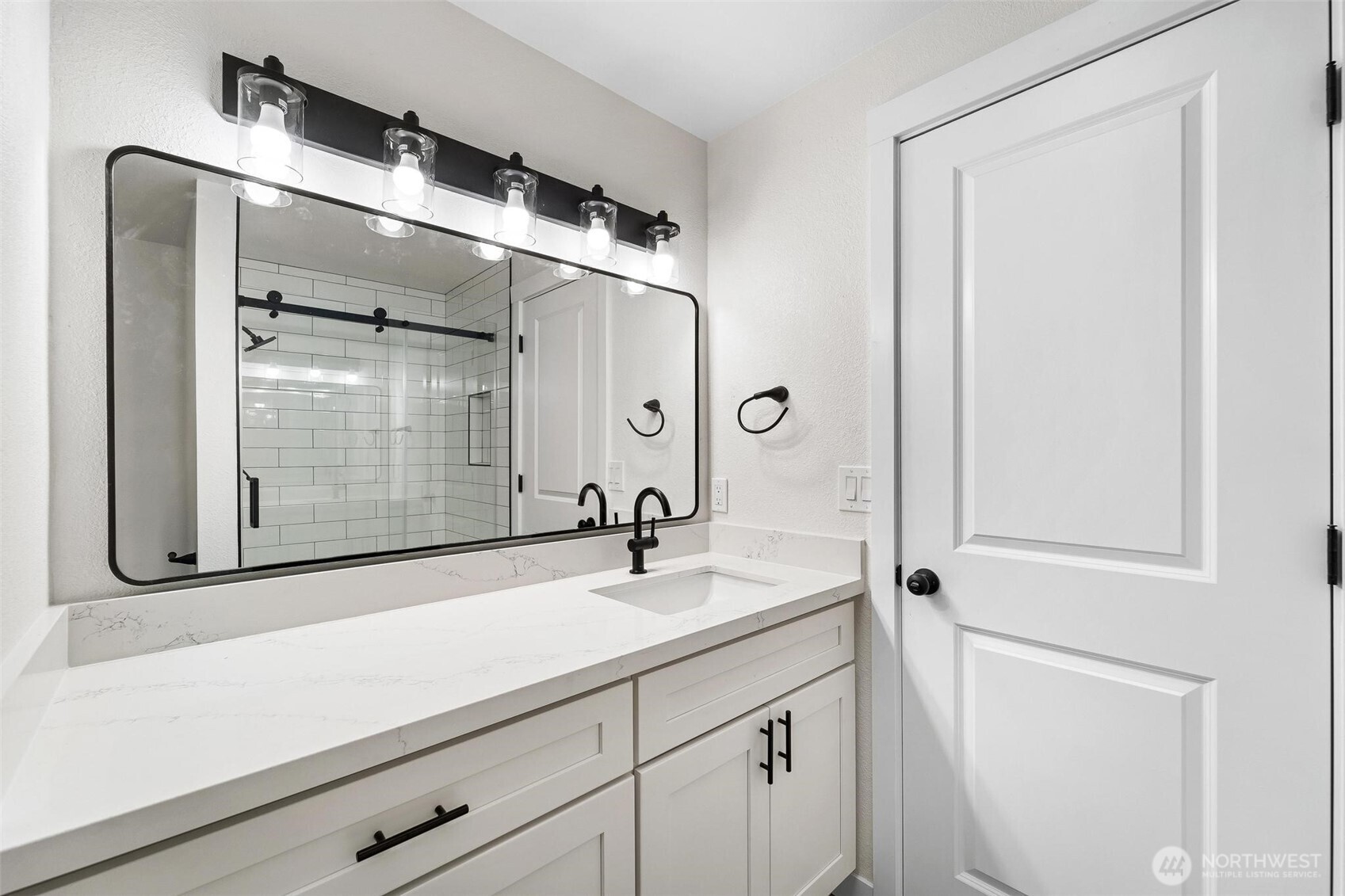 604 213th Street Southwest Bothell, WA 98021 - Photo 30 of 40 a bathroom with a sink a mirror and shower