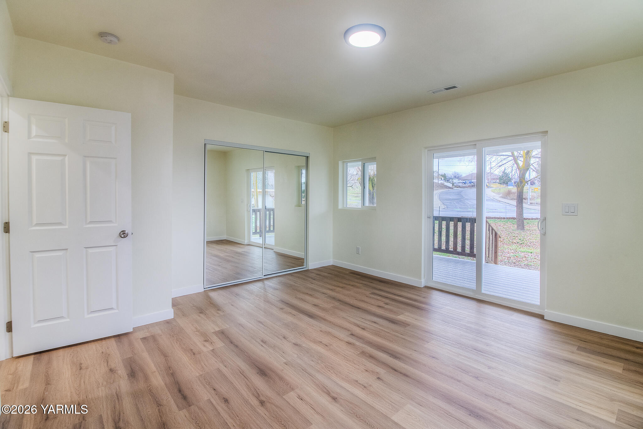 3503 Powerhouse Road Yakima, WA 98902 - Photo 12 of 27 an empty room with wooden floor and windows
