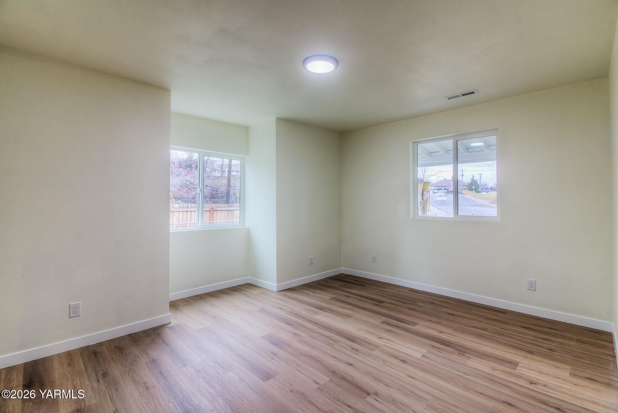 3503 Powerhouse Road Yakima, WA 98902 - Photo 15 of 27 an empty room with wooden floor and windows