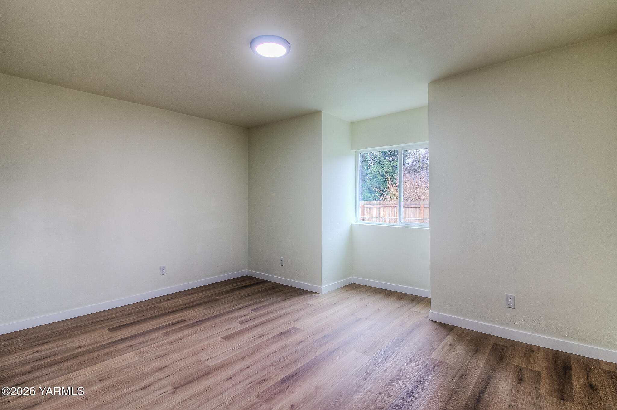 3503 Powerhouse Road Yakima, WA 98902 - Photo 17 of 27 an empty room with wooden floor and windows