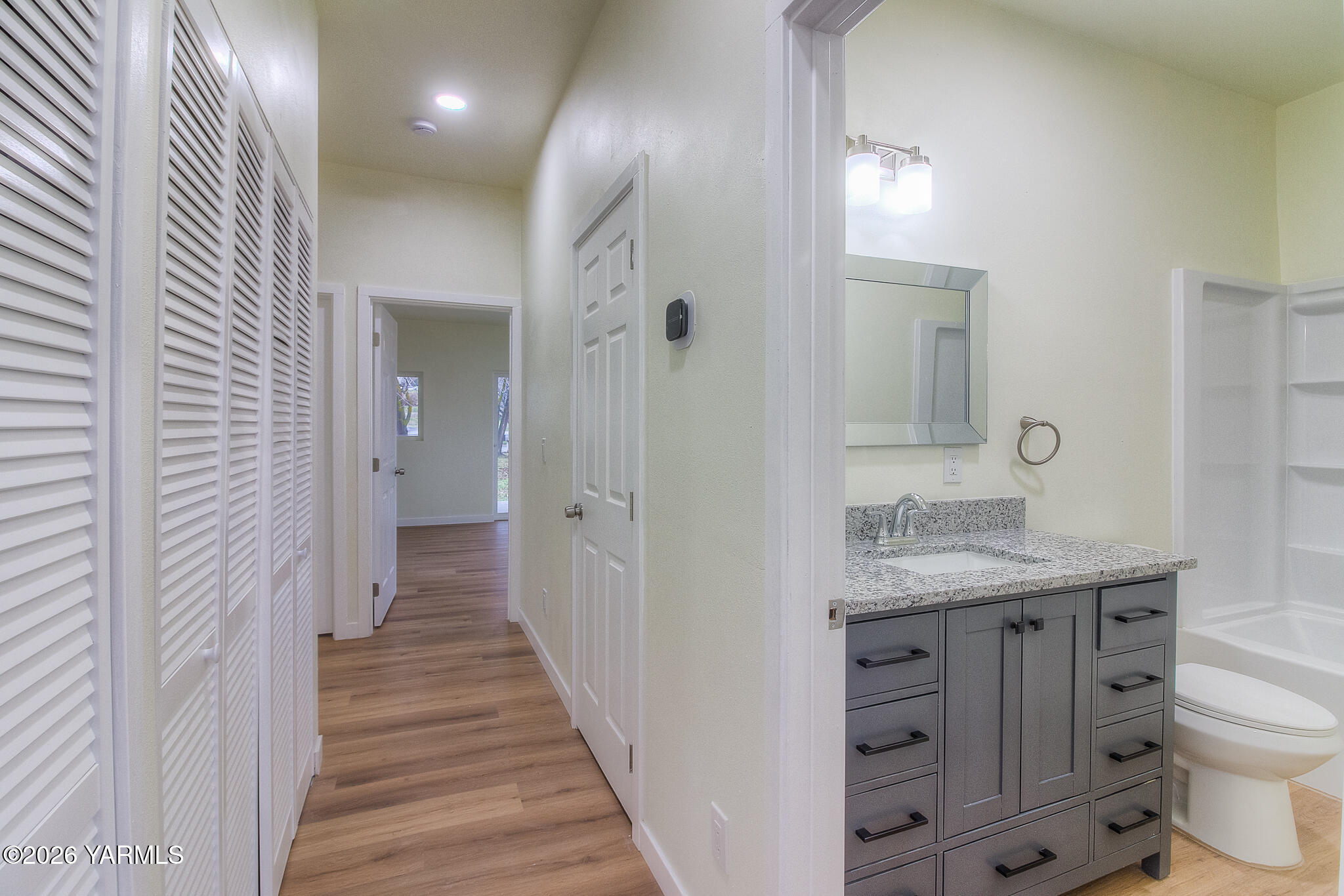 3503 Powerhouse Road Yakima, WA 98902 - Photo 20 of 27 a bathroom with a granite countertop sink a toilet and a large mirror