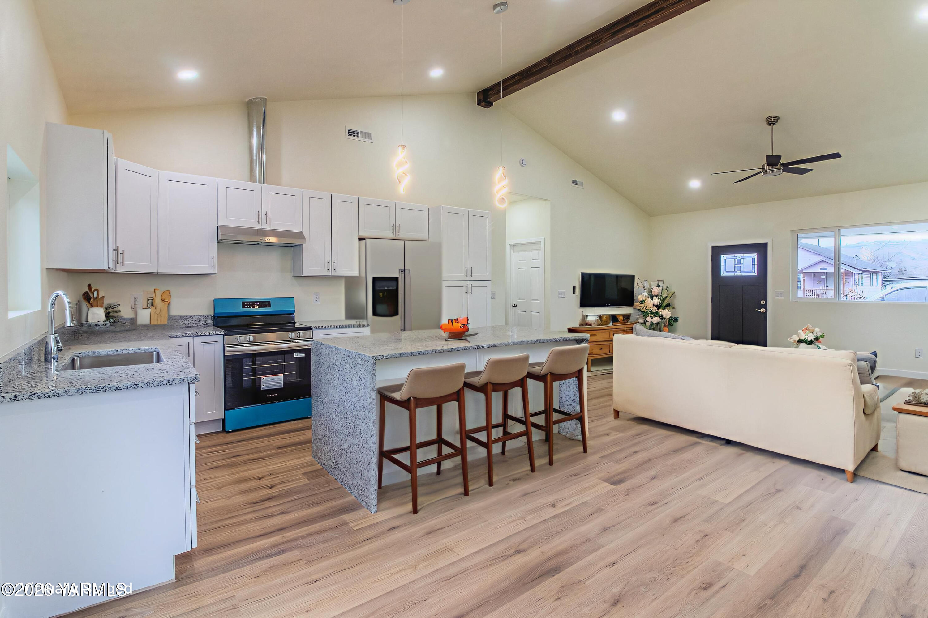 3503 Powerhouse Road Yakima, WA 98902 - Photo 4 of 27 a large kitchen with stainless steel appliances a table chairs refrigerator and a stove top oven